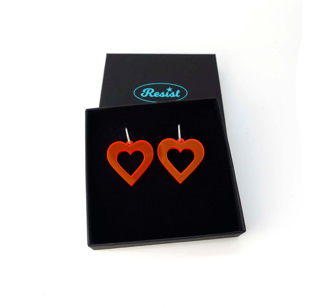 Big hot red fluorescent love heart hoop earrings shown in a Wear and Resist gift box. 