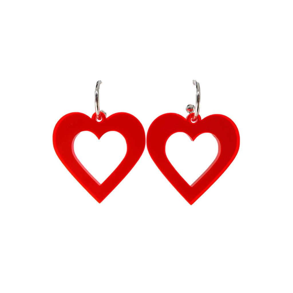 Big hot fluorescent red love heart hoop earrings shown hanging on a white background. 