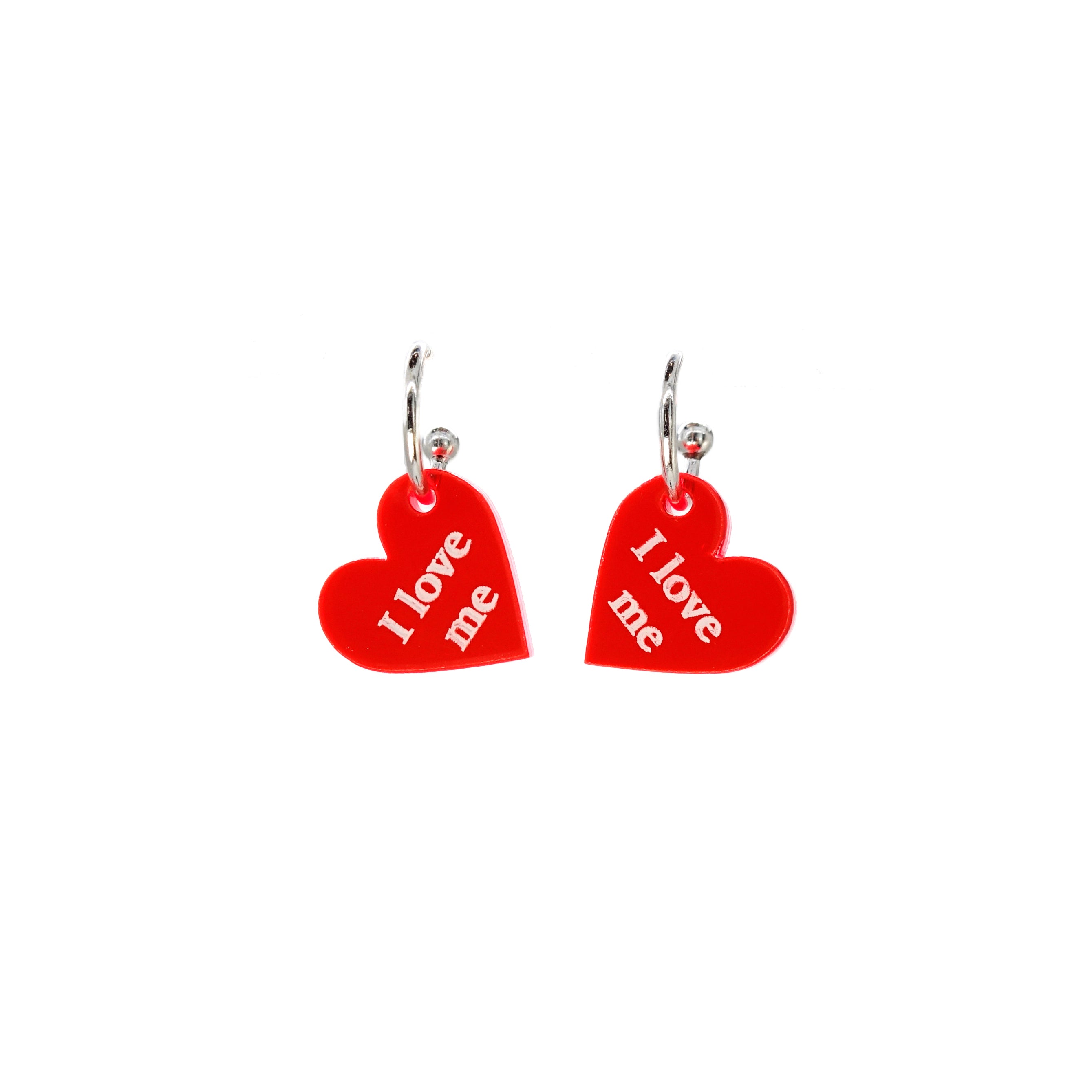 Small I Love Me etched heart earrings in transparent hot red on sterling silver plated hoops, shown against a white background. 