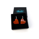 Hot red simple heart hoop earrings in a Wear and Resist gift box. 