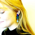 Model wears Midnight Deco Star drop earrings from side. 