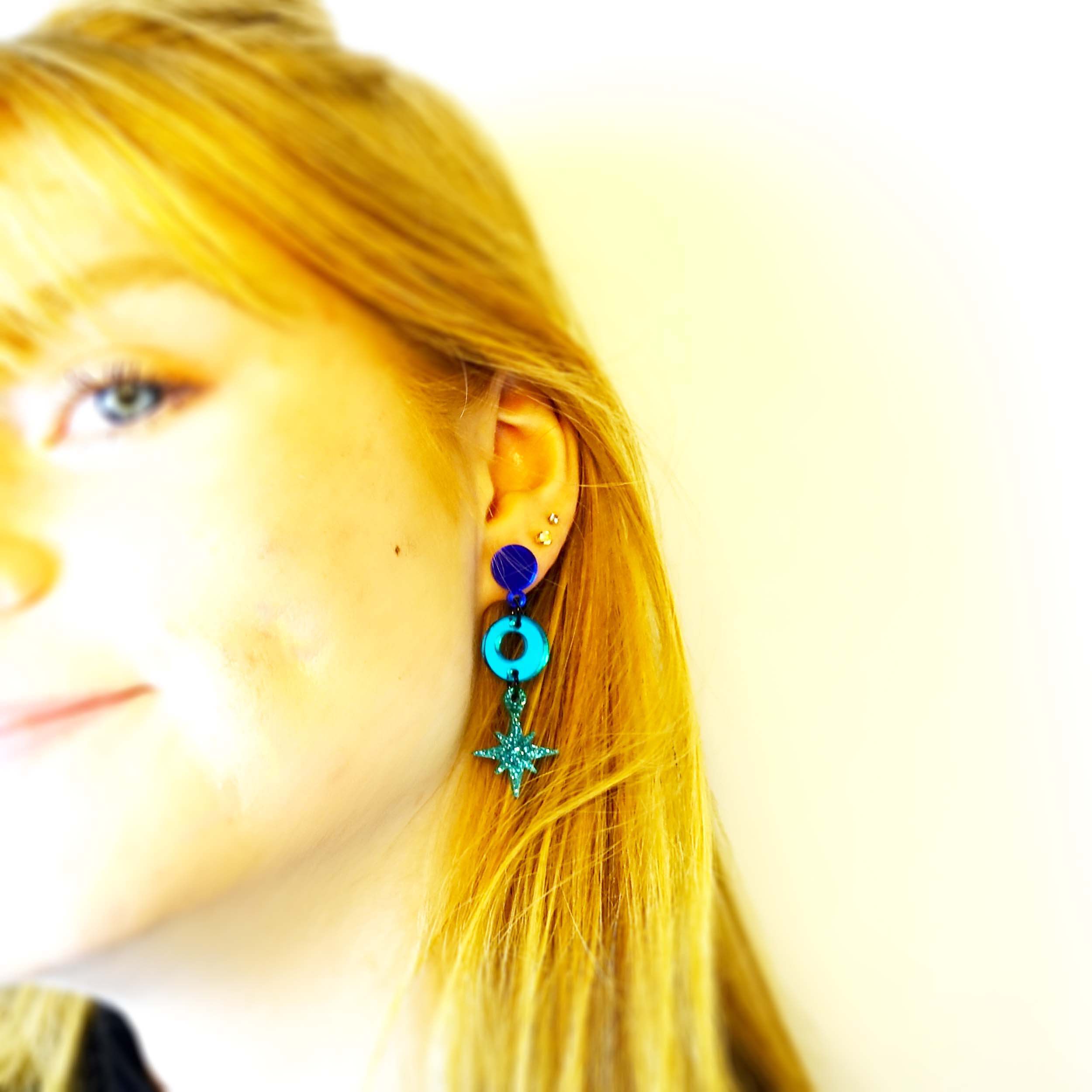 Model wears Midnight Deco Star drop earrings. 