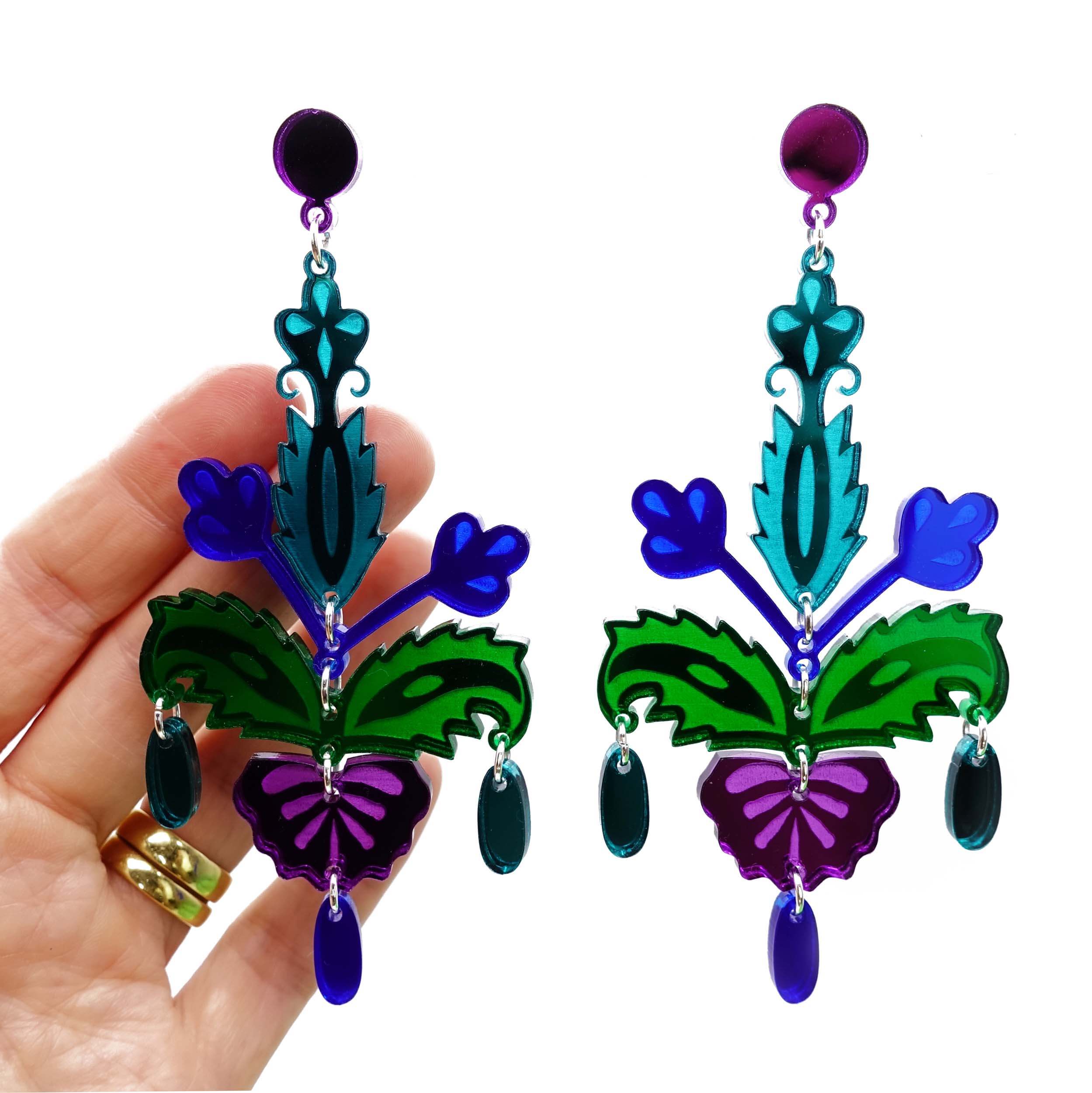 Midnight blue, green and purple mirror large statement Festival drop earrings designed by Sarah Day for Wear and Resist, shown hanging with a hand behind for scale. 