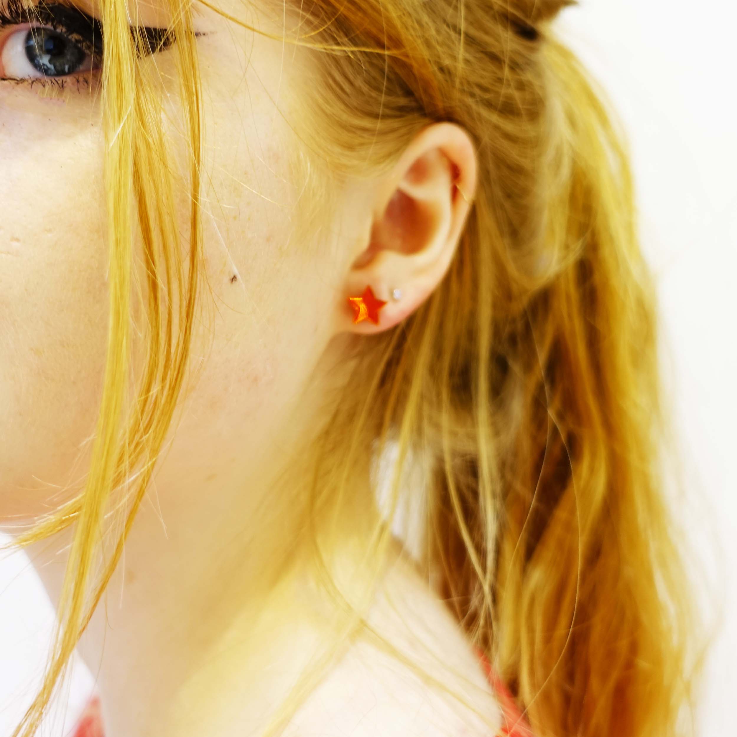 model wearing fire mirror little star earrings