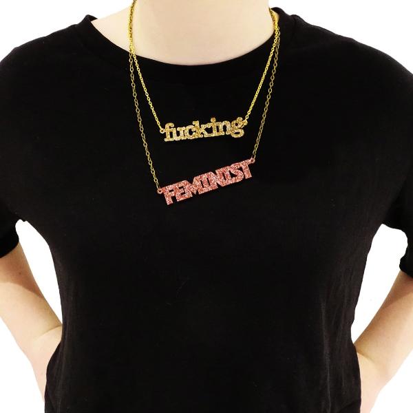 model wears glitter gold fucking necklace with feminist necklace fucking feminist