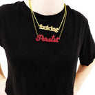 model wears glitter gold fucking necklace with persist necklace double stranding it