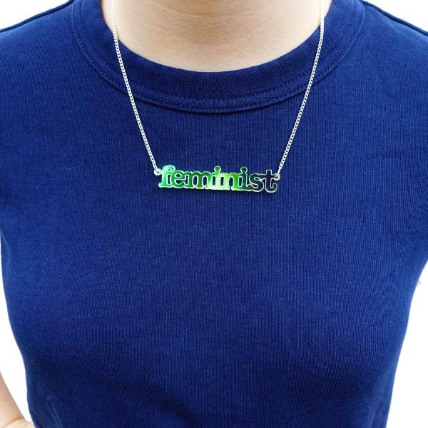 model wearing iridescent typewriter font feminist necklace