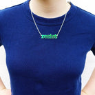 model wears iridescent typewriter font persist necklace