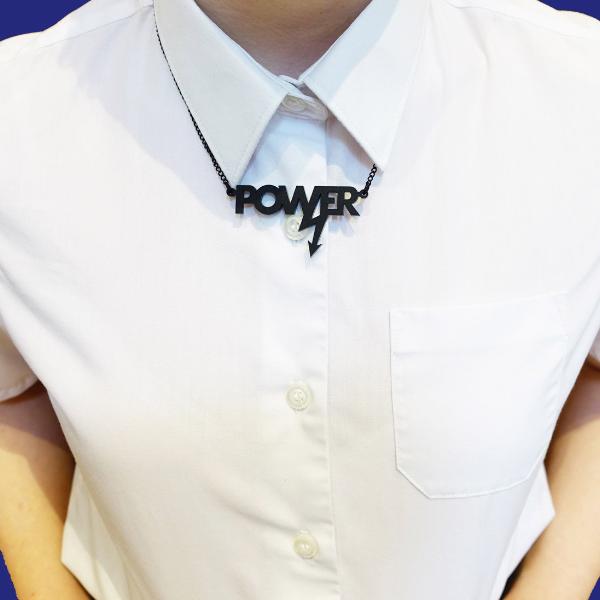 Model wears a mini power necklace in matte black. 