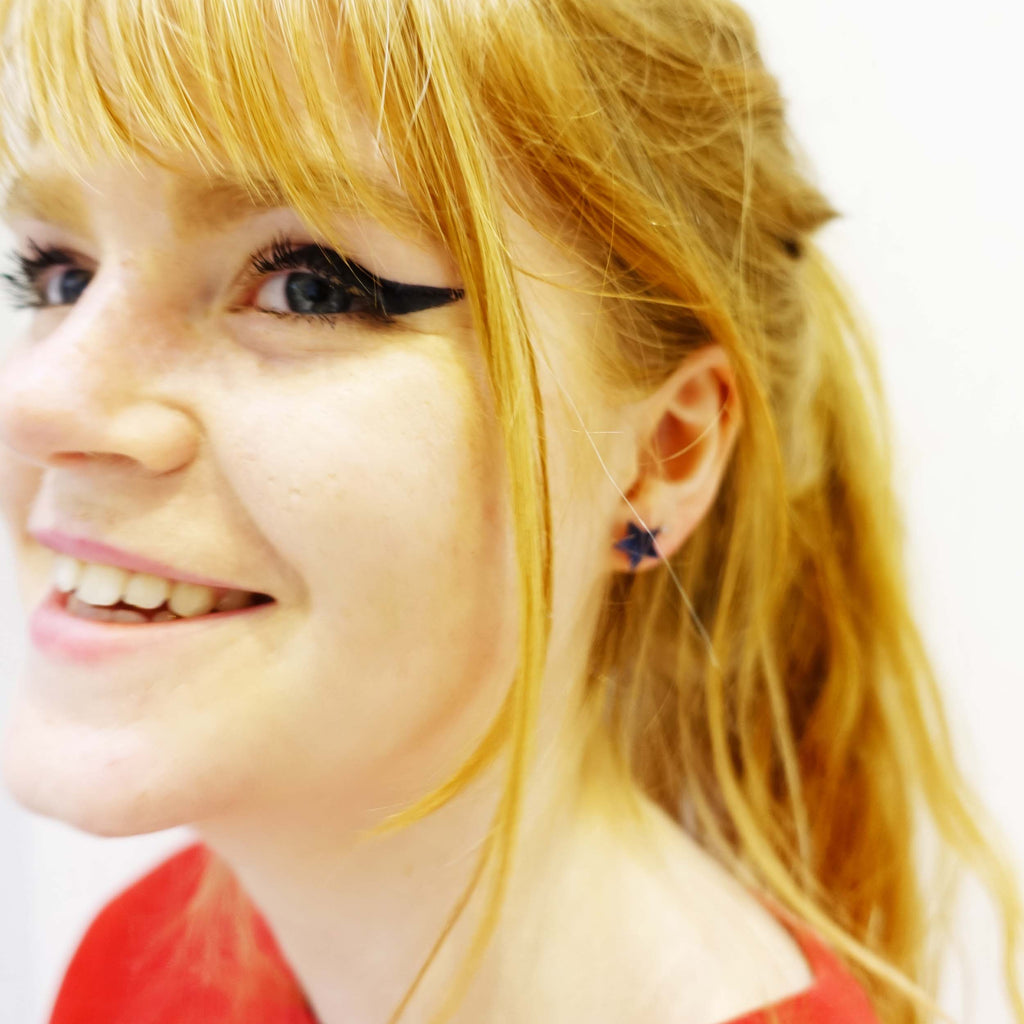 model wearing slate mirror star earrings