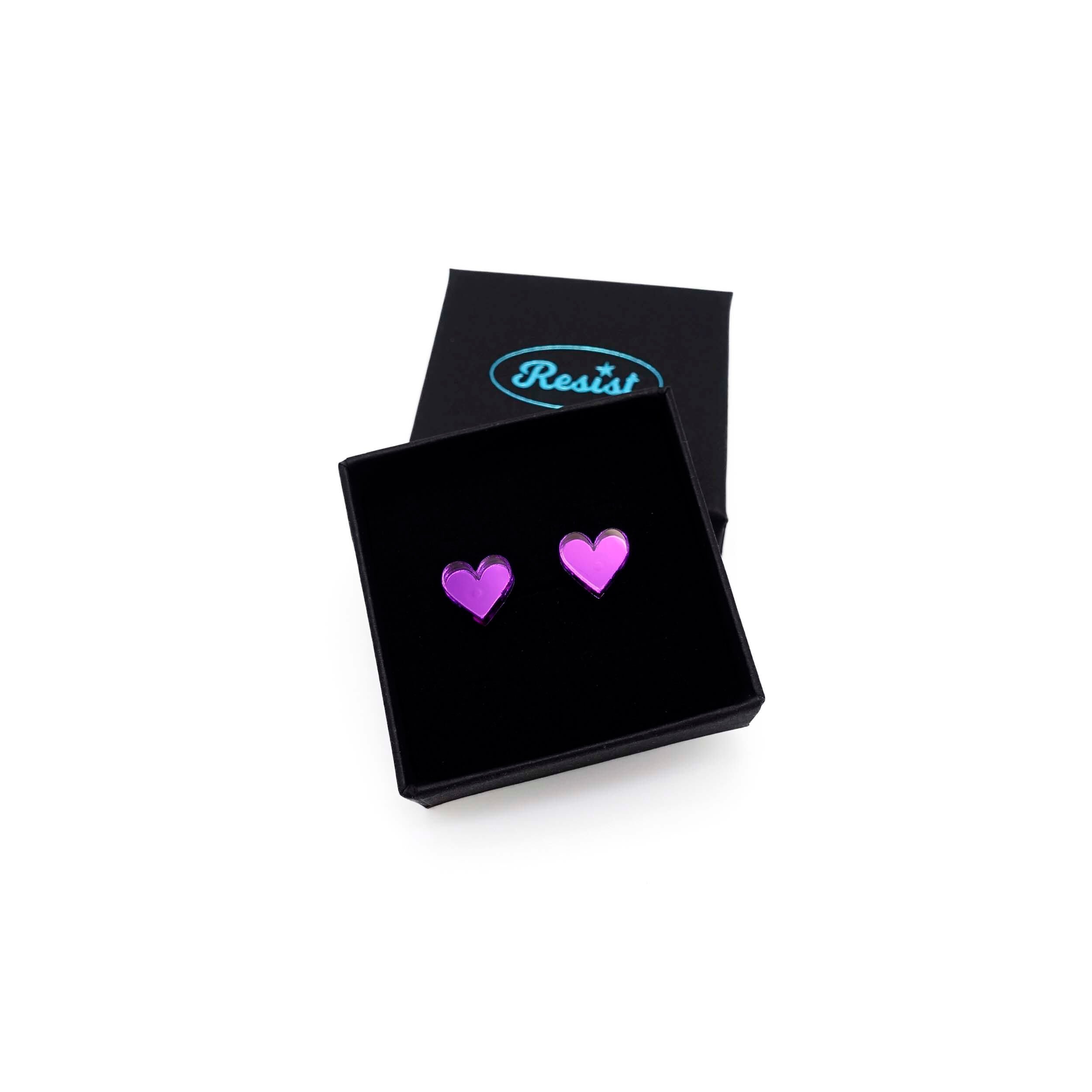 Poison purple mirror mirror tiny heart stud earrings shown in a Wear and Resist gift box. 
