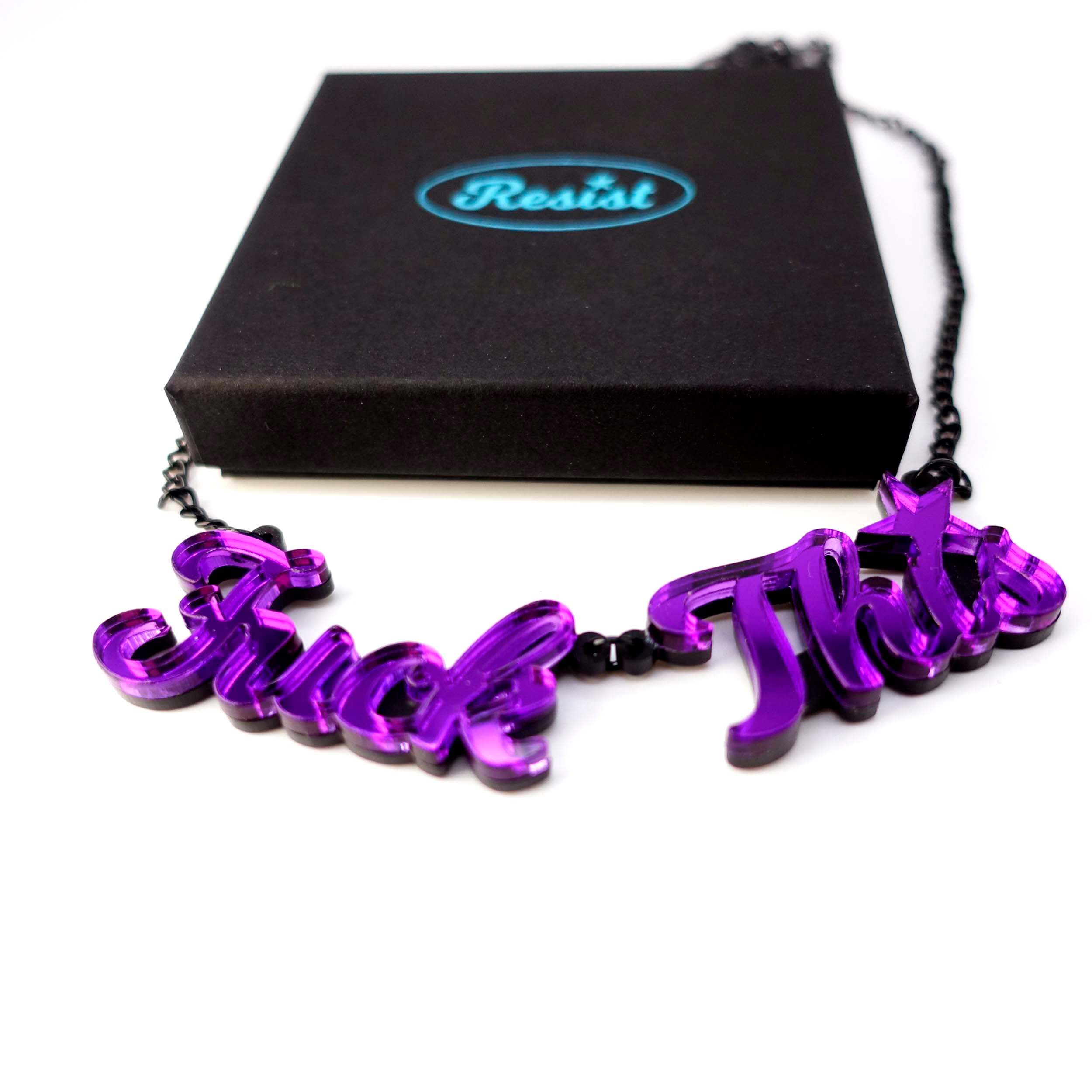 A purple mirror F*ck This necklace shown with a Wear and Resist gift box. 