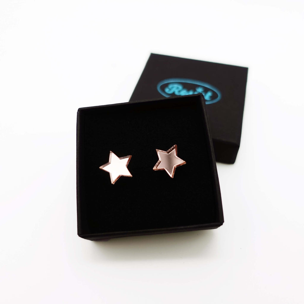 Rose gold mirror star stud earrings shown in box. 