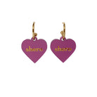 Shero heart earrings on gold plated hoops shown against a white background. 