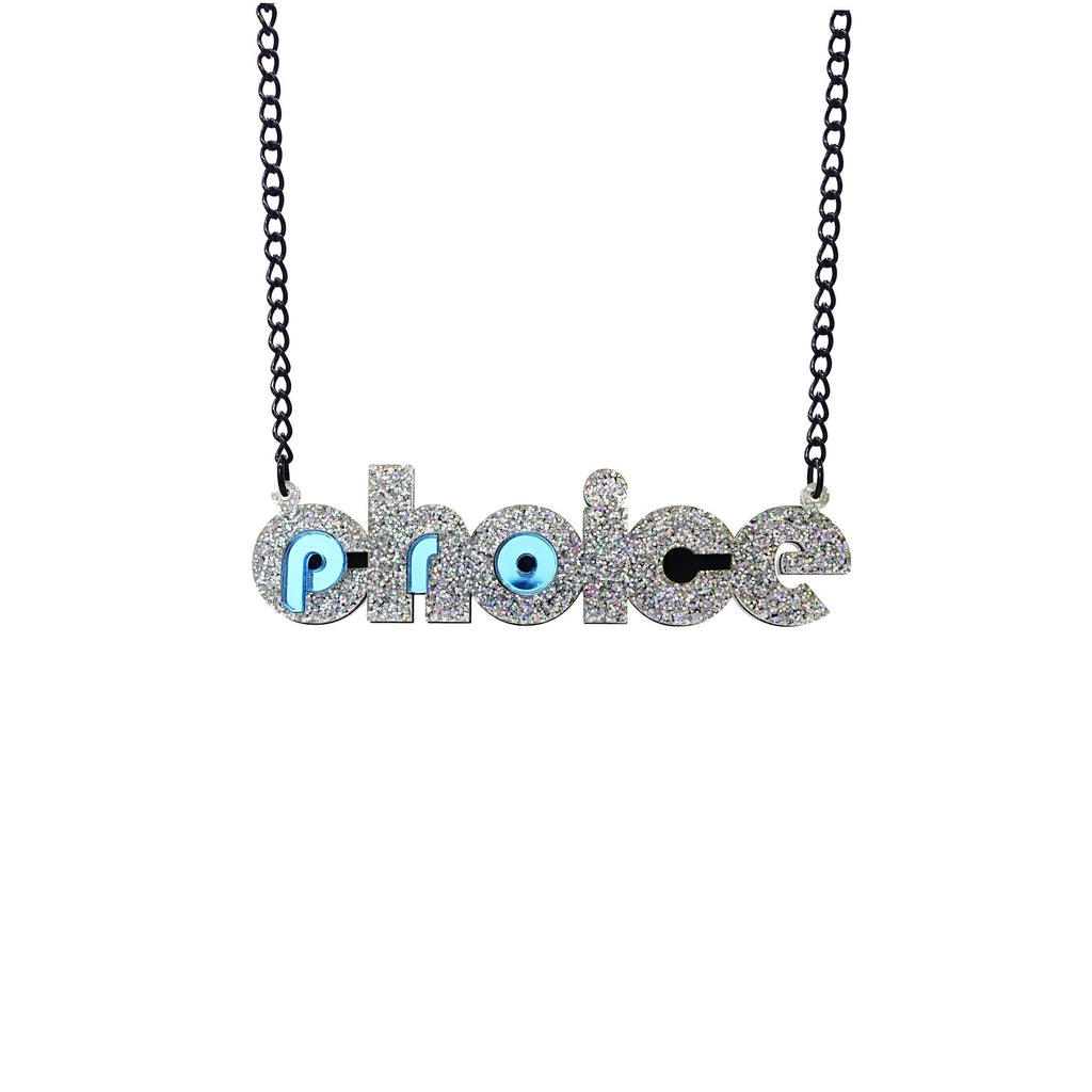 Iridescent silver glitter and sky blue mirror Pro-choice necklace, shown hanging on black chain, designed by Sarah Day for Wear and Resist. £2 goes to Alliance for Choice who campaign  for Free, Safe and Legal abortions for anyone who needs them. 
