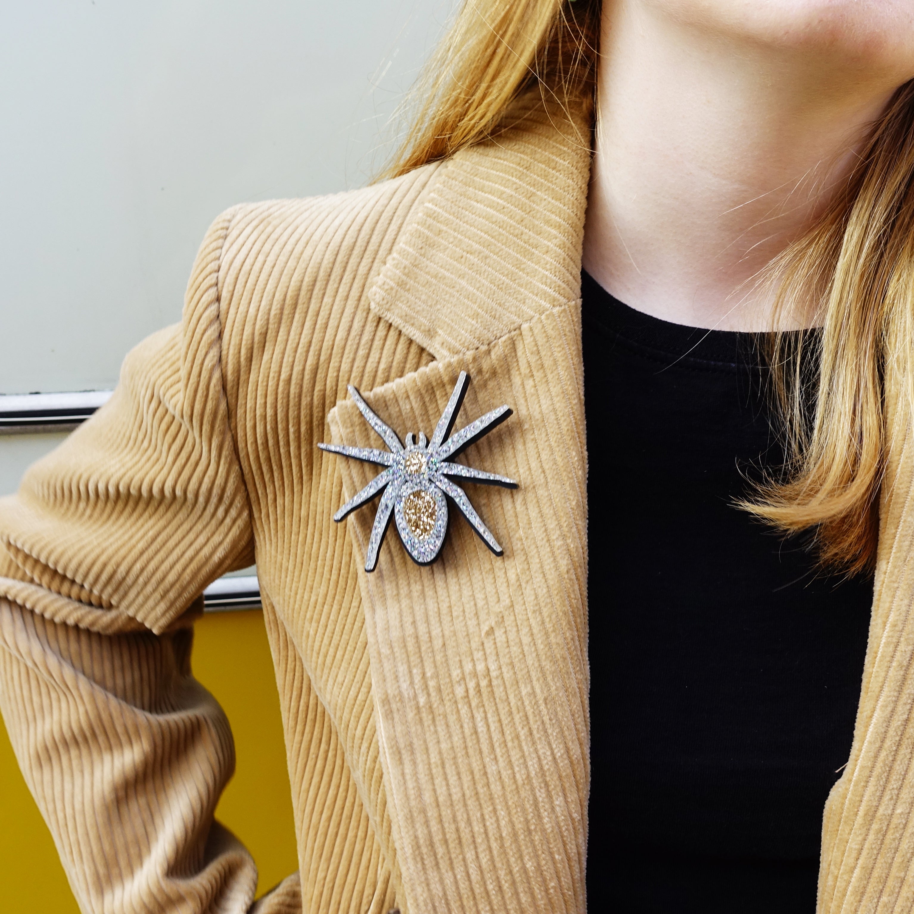 Silver Lady Hale Spider brooch shown worn on a jacket. 