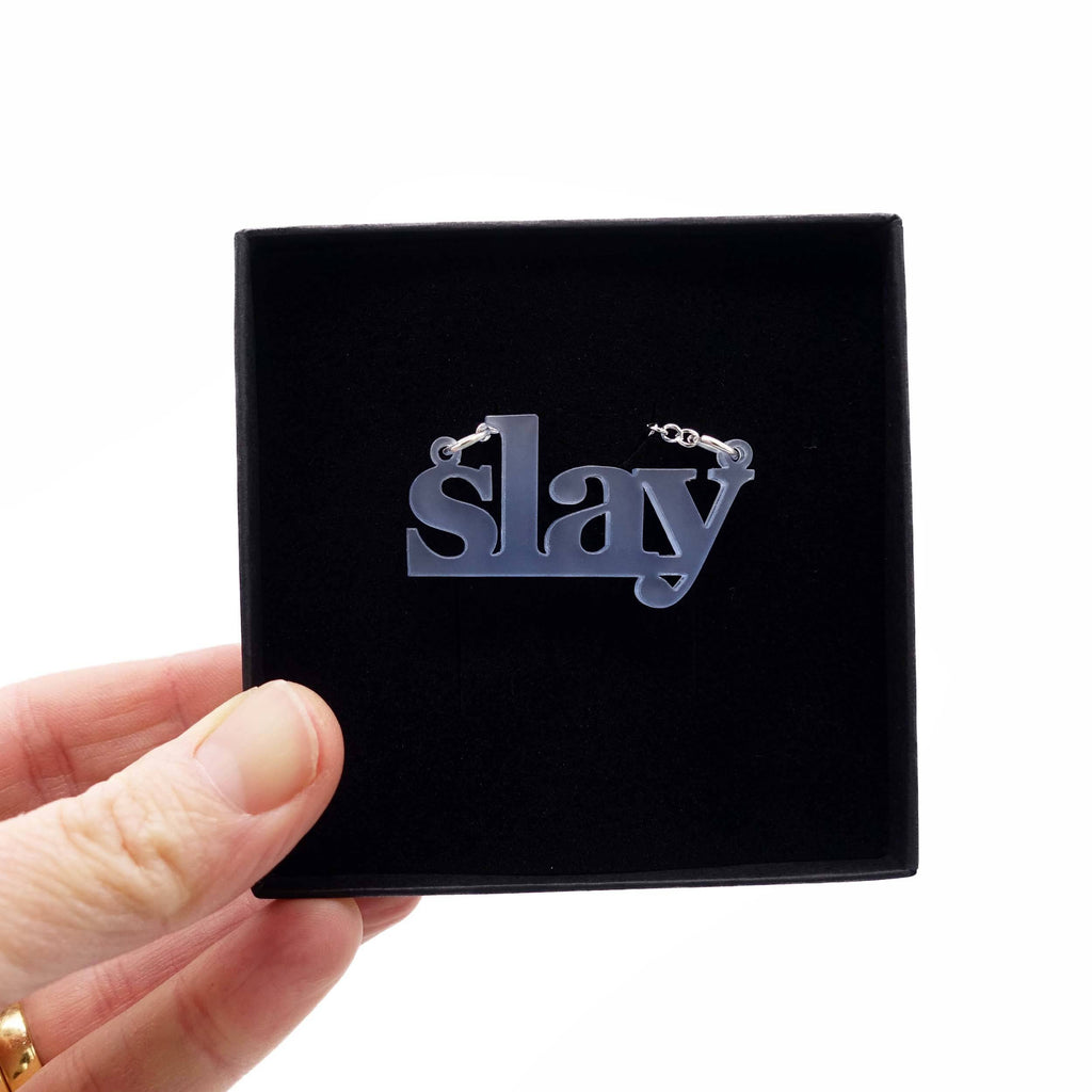 Sky frost Slay necklace shown being held up in a gift box. 