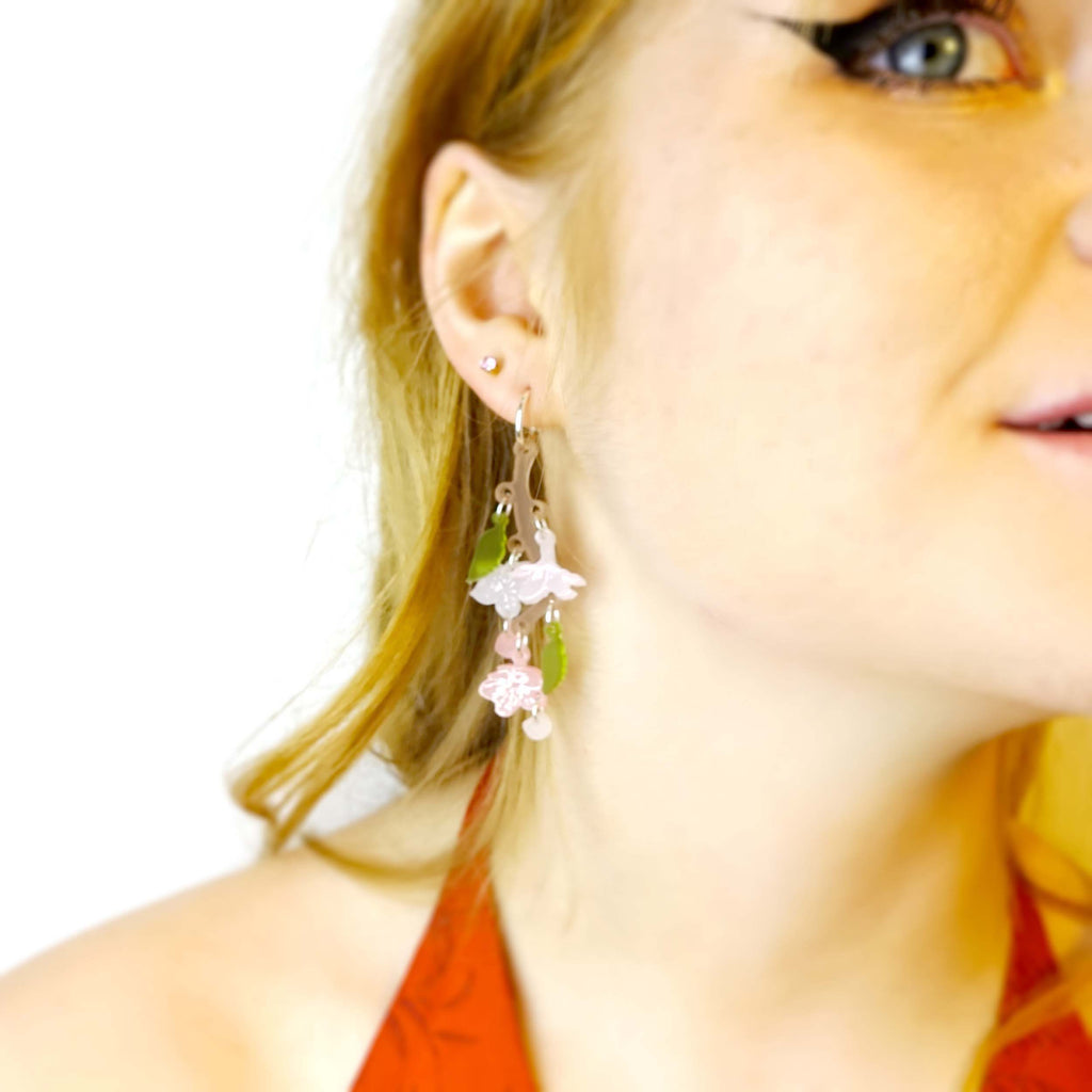 Model wears Cherry Blossom limited edition earrings designed by Sarah Day for Wear and Resist. 