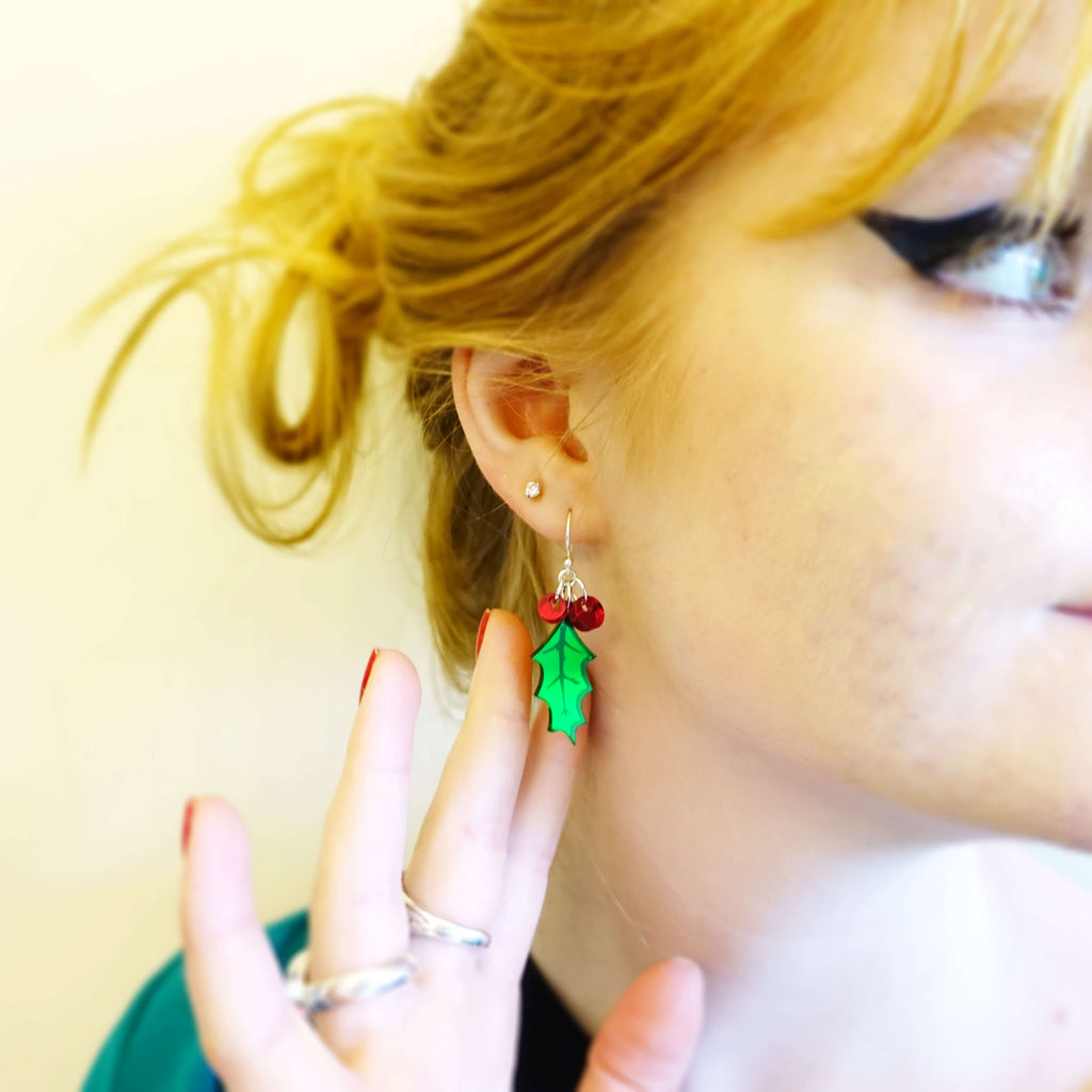 Model wears small Holly earrings with tiny red berries by Wear and Resist, perfect for Xmas parties! 