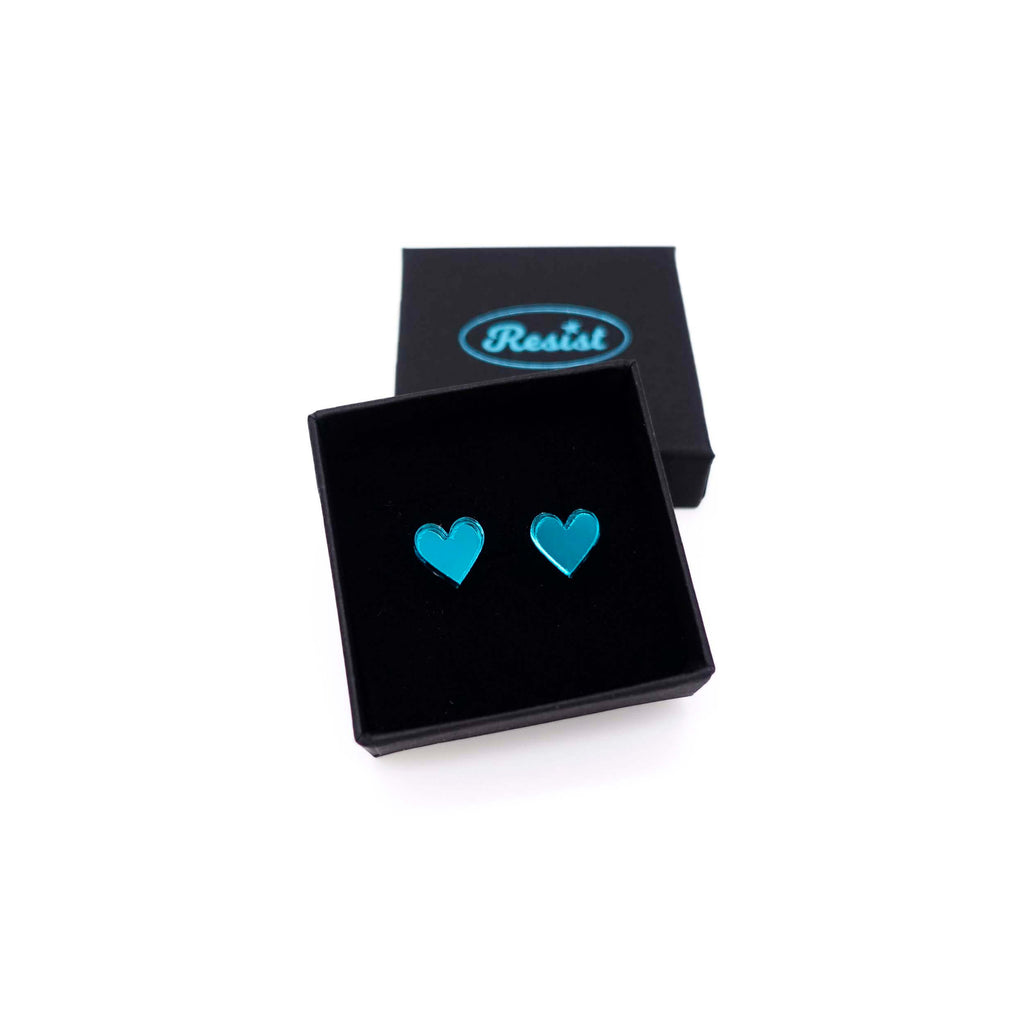Teal mirror tiny heart stud earrings shown in a Wear and Resist gift box. 