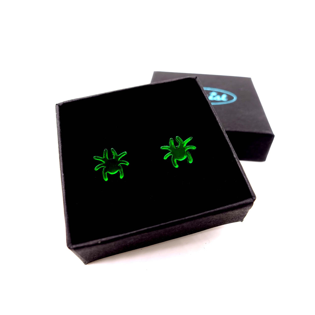 Tiny spider earrings in new envy green shown in gift box. 