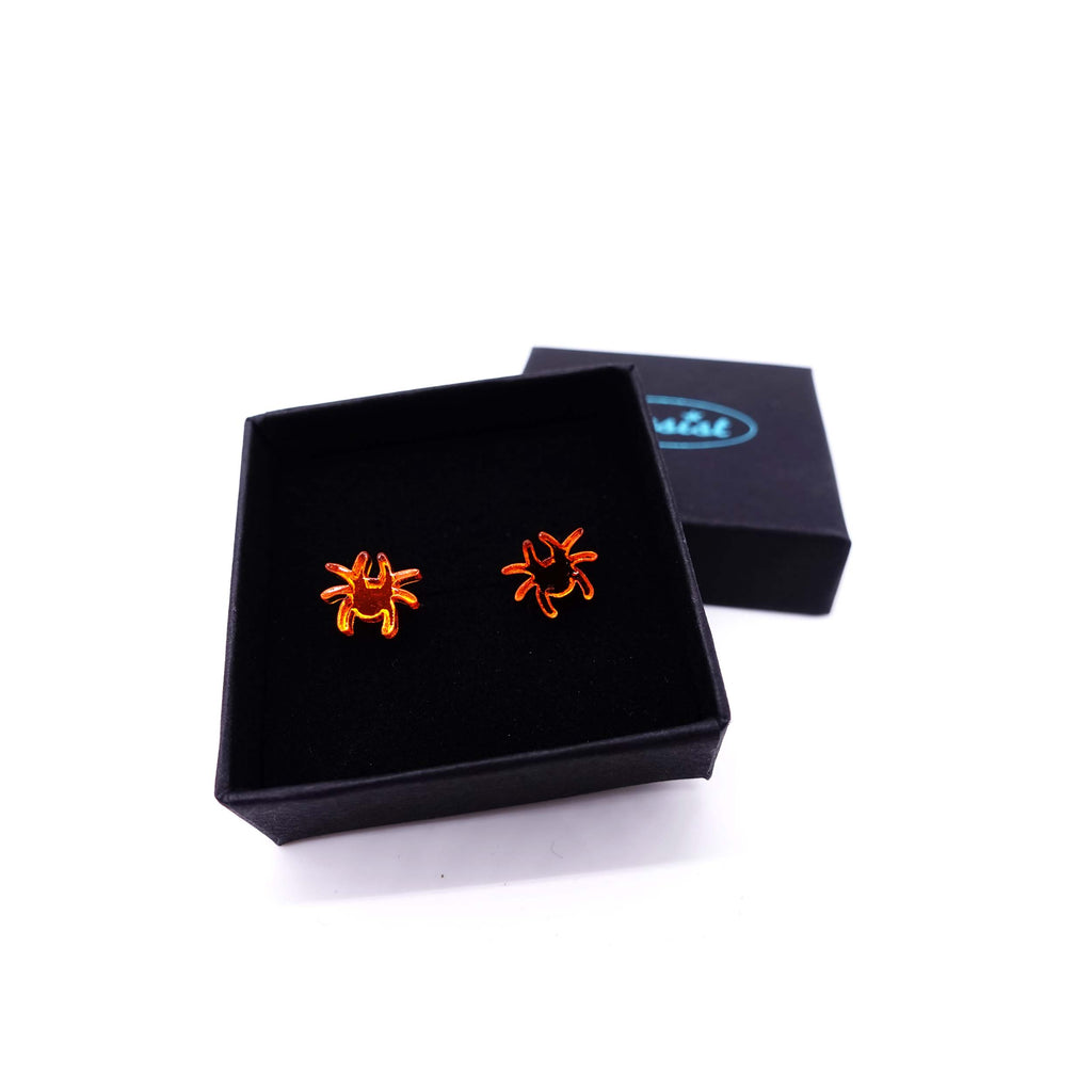 Tiny spider earrings in flame mirror shown in gift box. 