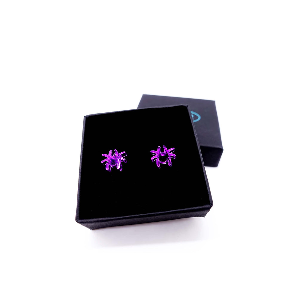 Tiny spider earrings in new poison purple shown in gift box. 