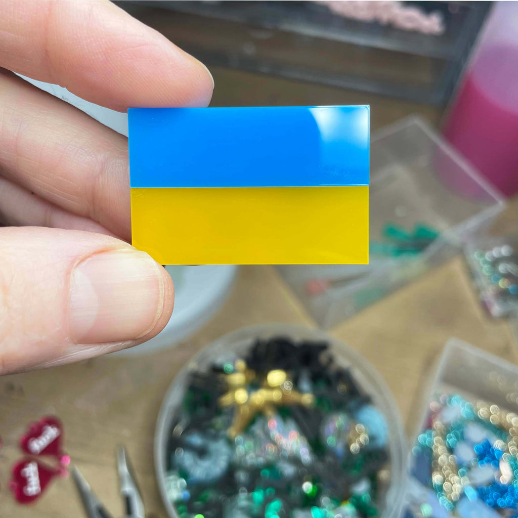 I Stand With Ukraine pin or badge designed by Sarah Day for Wear and Resist. All proceeds go to the Disaster Emergency Commitee to help with the crisis in Ukraine. Shown in Sarah's studio. 