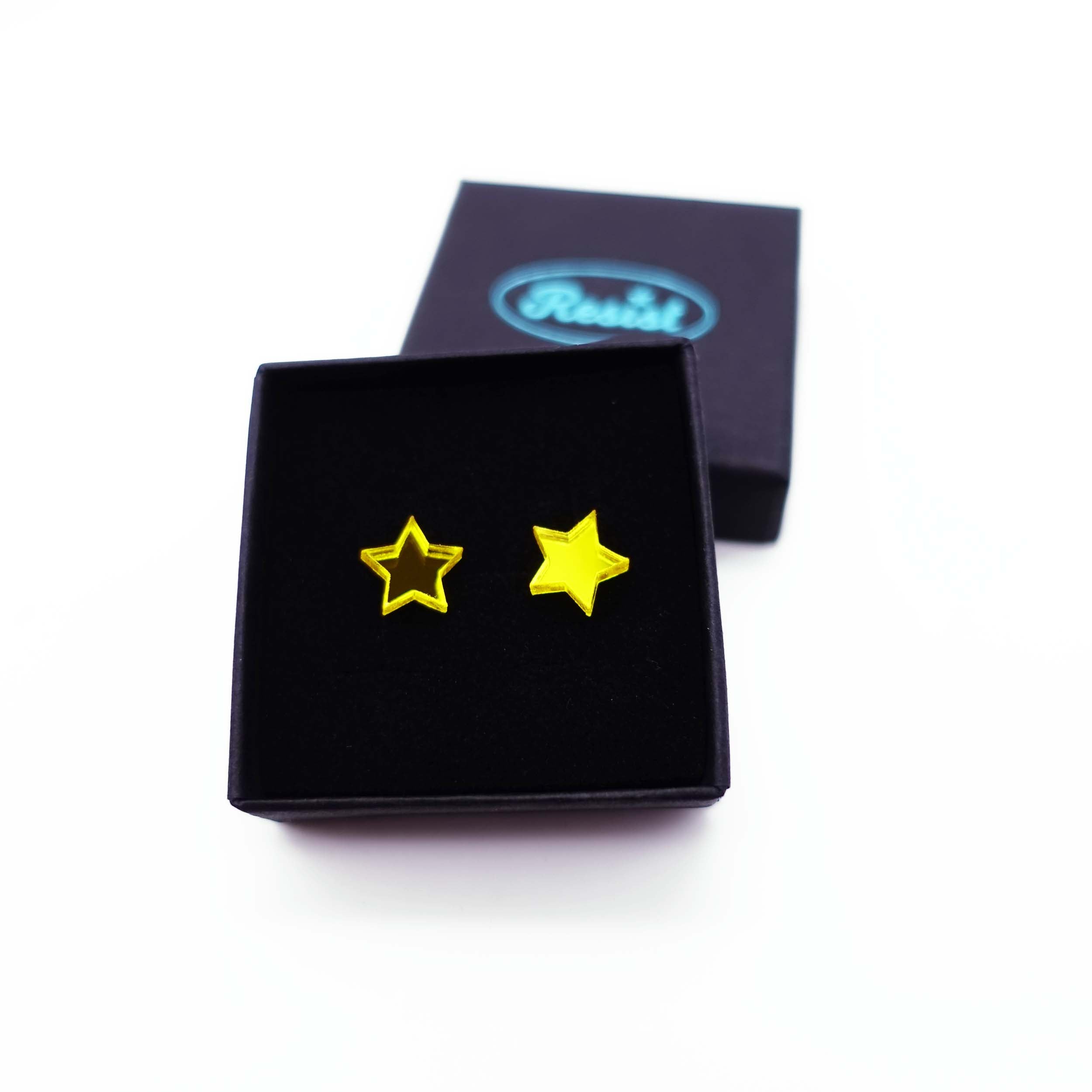 Yellow mirror star stud earrings shown in box. 